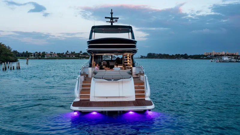 Slide: The Image of 2025 Princess S72 yacht with illuminated deck cruising on serene waters at sunset. - 4