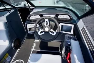 Slide: The Image of 2025 MasterCraft NXT22 boat cockpit with modern steering and digital displays. - 12