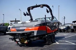 Slide: The Image of 2025 MasterCraft NXT22 boat in parking lot, rear view, sleek design, vibrant colors. - 3