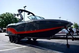 Slide: The Image of 2025 MasterCraft NXT22 boat on trailer, sleek design, black and red accents. - 5