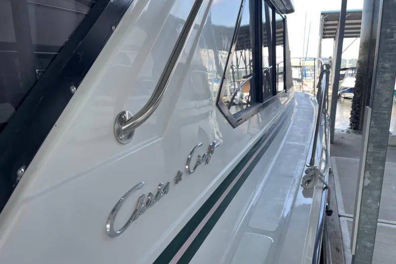 Slide: The Image of 1988 Chris-Craft 392 Sport Fish boat docked, showcasing sleek design and chrome details. - 1