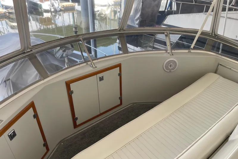 Slide: The Image of 1988 Chris-Craft 392 Sport Fish interior with seating and storage compartments. - 11