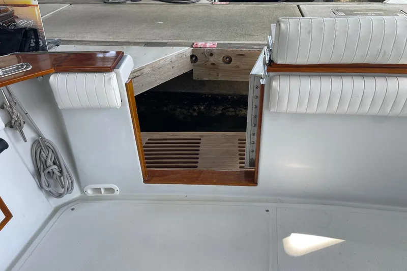 Slide: The Image of 1988 Chris-Craft 392 Sport Fish boat interior with white seating and wooden accents. - 18