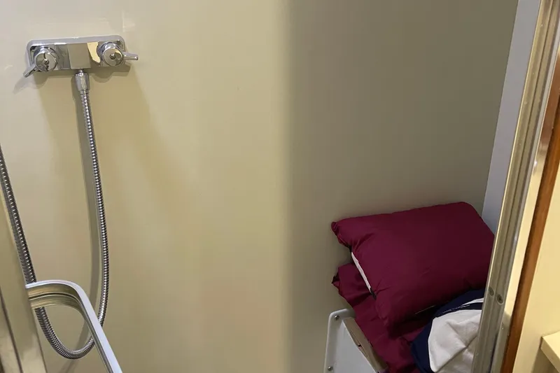 Slide: The Image of 1988 Chris-Craft 392 Sport Fish interior with shower and bedding. - 20