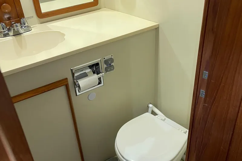 Slide: The Image of 1988 Chris-Craft 392 Sport Fish yacht bathroom with sink and toilet. - 22