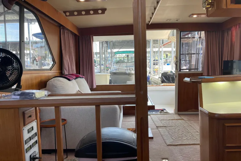 Slide: The Image of Interior of 1988 Chris-Craft 392 Sport Fish boat with cozy seating and wooden accents. - 23