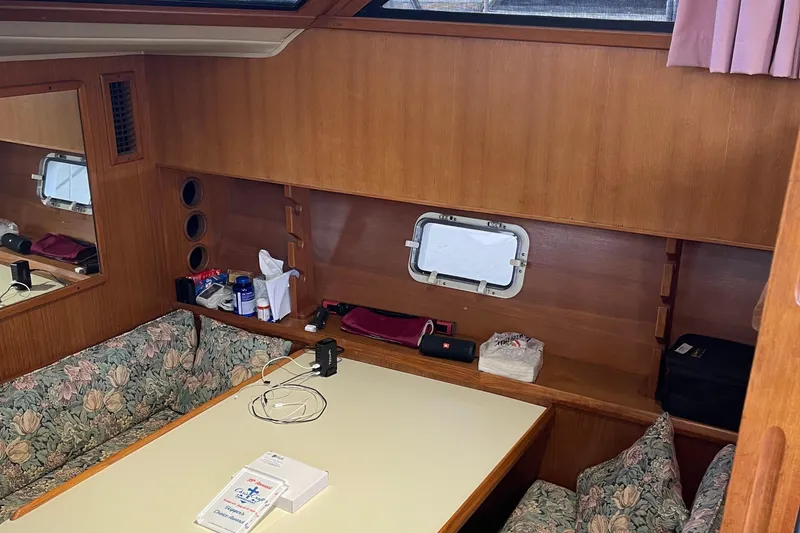 Slide: The Image of Interior of 1988 Chris-Craft 392 Sport Fish with wooden paneling and floral seating. - 25