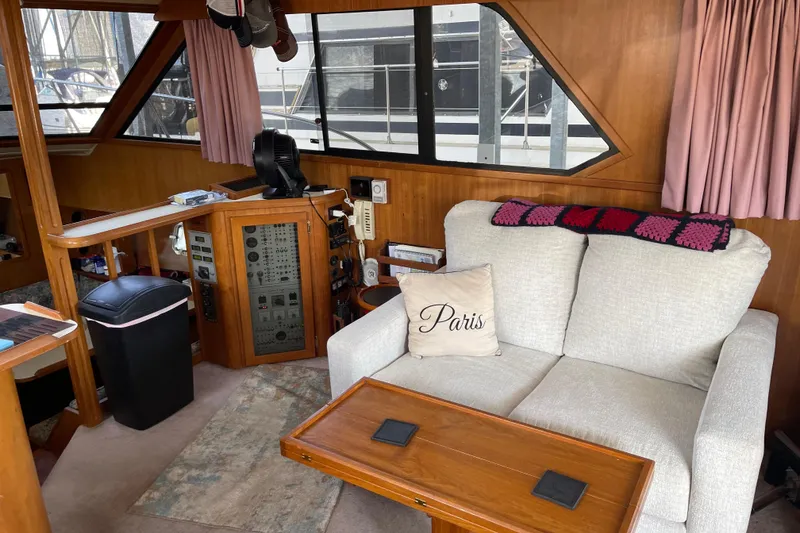 Slide: The Image of 1988 Chris-Craft 392 Sport Fish interior with sofa, control panel, and nautical decor. - 3