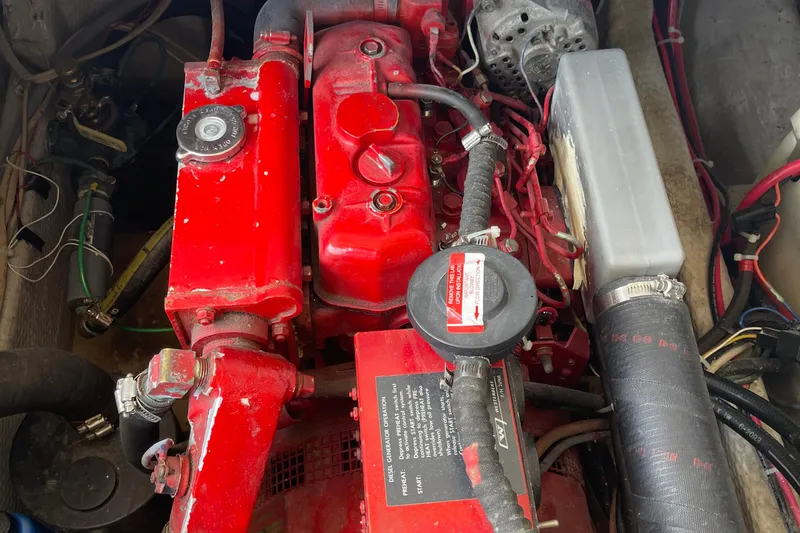 Slide: The Image of Engine compartment of a 1988 Chris-Craft 392 Sport Fish boat, featuring red components. - 31