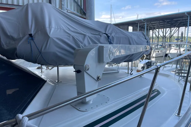 Slide: The Image of 1988 Chris-Craft 392 Sport Fish boat deck with covered equipment and marina background. - 40