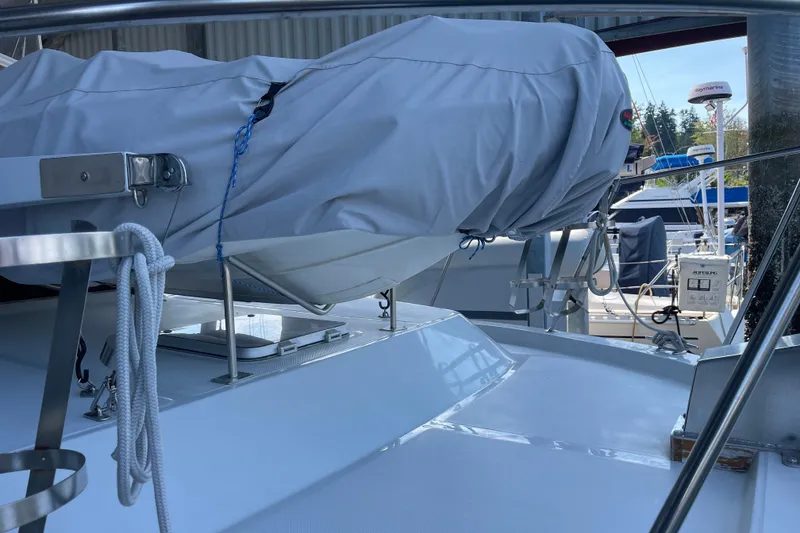 Slide: The Image of 1988 Chris-Craft 392 Sport Fish boat deck with covered equipment and marina background. - 42