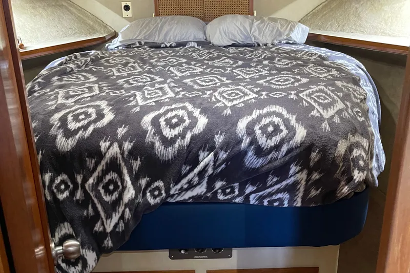 Slide: The Image of Cozy cabin bed in 1988 Chris-Craft 392 Sport Fish boat with patterned blanket. - 5