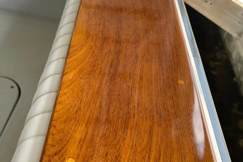 Slide: The Image of Polished wooden surface on 1988 Chris-Craft 392 Sport Fish boat, showcasing craftsmanship. - 8