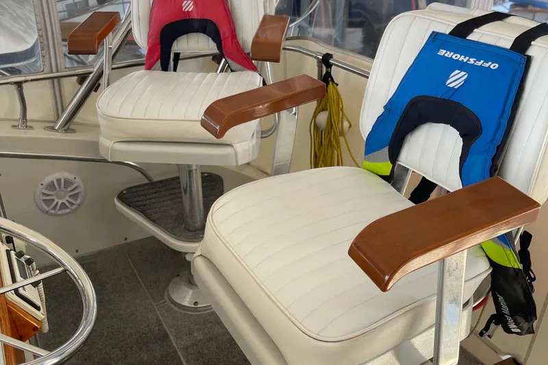 Slide: The Image of 1988 Chris-Craft 392 Sport Fish boat interior with white seats and life jackets. - 9