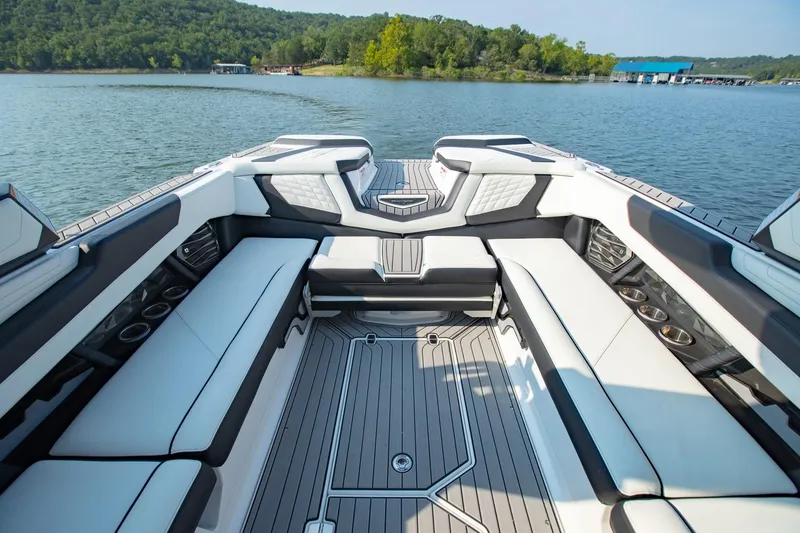 Slide: The Image of Luxurious interior of 2022 Nautique Super Air Nautique G25 on a serene lake. - 10