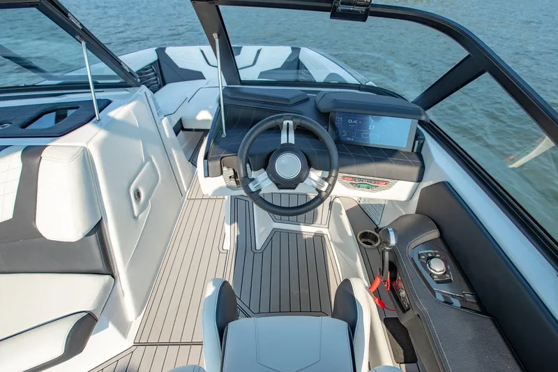 Slide: The Image of 2022 Nautique Super Air Nautique G25 cockpit with modern steering and digital display. - 13
