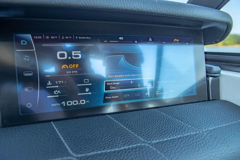 Slide: The Image of 2022 Nautique Super Air Nautique G25 dashboard display showing speed, depth, and wave settings. - 14