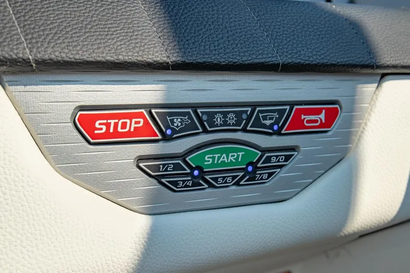 Slide: The Image of Control panel of 2022 Nautique Super Air Nautique G25 boat with start and stop buttons. - 17