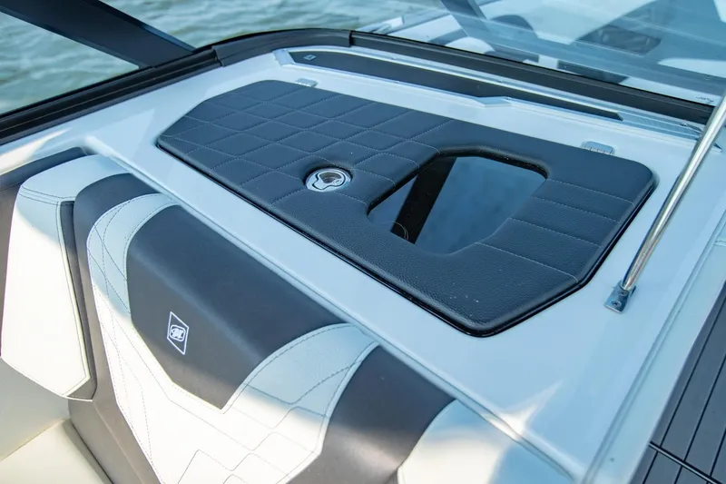 Slide: The Image of 2022 Nautique Super Air Nautique G25 interior detail with sleek seating and storage compartment. - 18