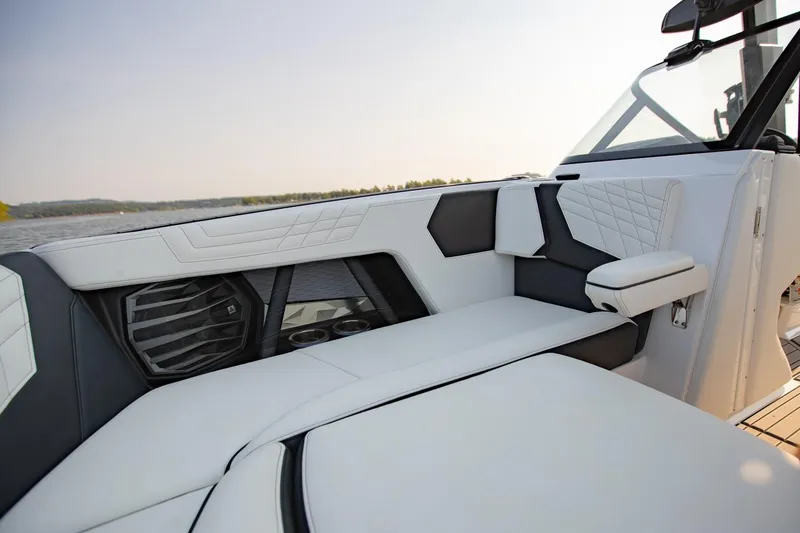 Slide: The Image of 2022 Nautique Super Air Nautique G25 interior with luxurious seating and speaker system. - 21