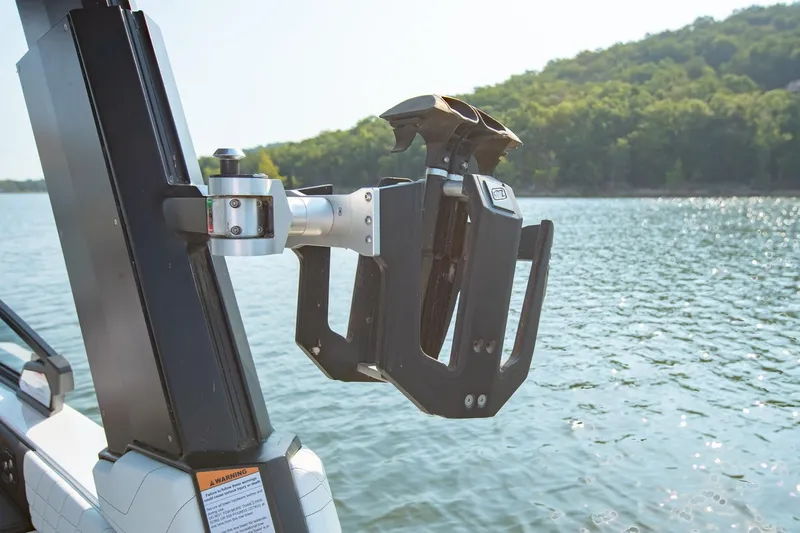 Slide: The Image of Wakeboard rack on 2022 Nautique Super Air Nautique G25, lake view background. - 28