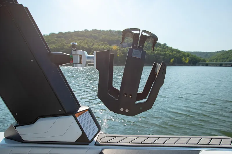 Slide: The Image of 2022 Nautique Super Air Nautique G25 wakeboard rack on a scenic lake. - 29