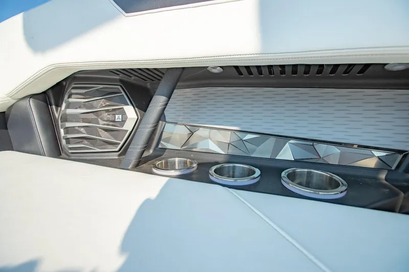 Slide: The Image of Interior of 2022 Nautique Super Air Nautique G25 with speaker and cup holders. - 30