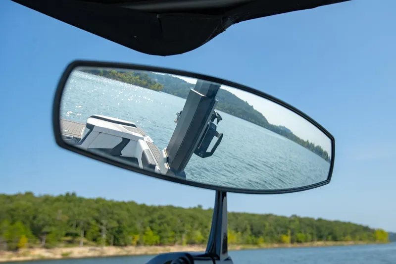 Slide: The Image of Rearview mirror reflection of 2022 Nautique Super Air Nautique G25 on a scenic lake. - 35