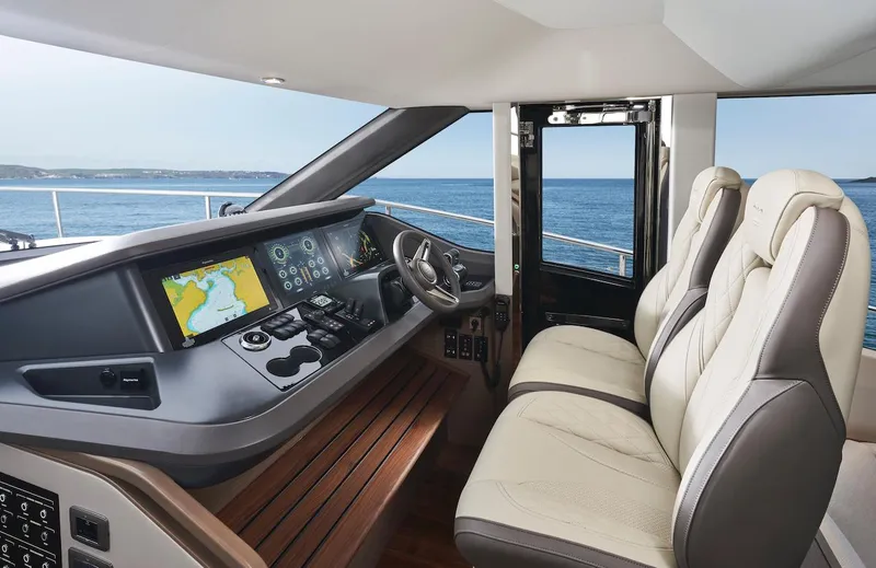Slide: The Image of 2025 Princess Y72 Motor Yacht helm with modern navigation displays and luxurious seating. - 17