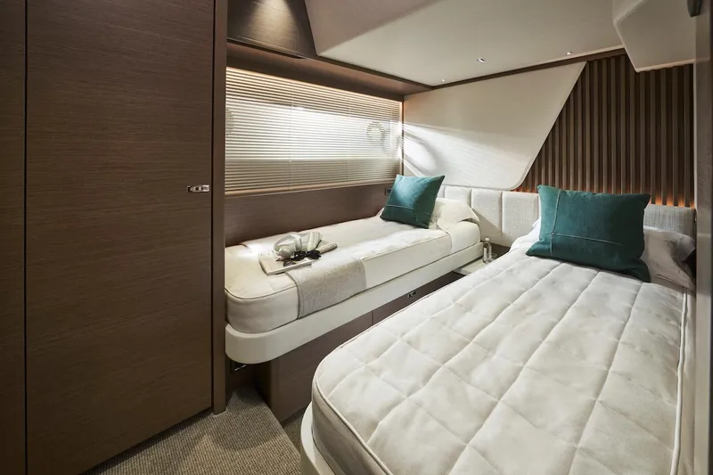 Slide: The Image of Luxurious cabin interior of 2025 Princess Y72 Motor Yacht with twin beds and elegant decor. - 33