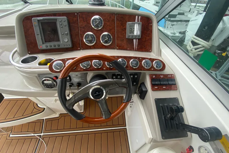 Slide: The Image of 2004 Formula 370ss boat dashboard with steering wheel, gauges, and navigation controls. - 17