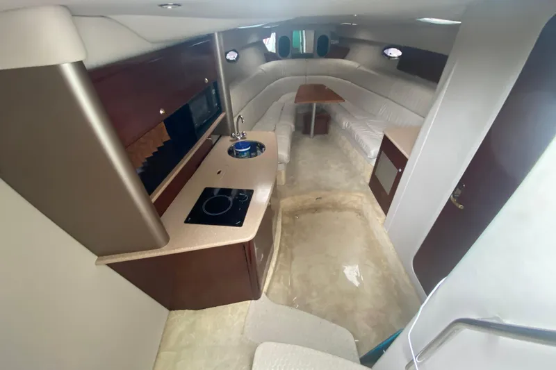 Slide: The Image of Interior of a 2004 Formula 370ss boat with kitchenette and seating area. - 21