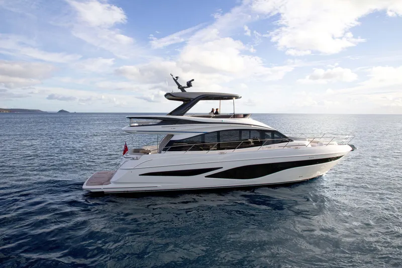 The Image of Luxury 2025 Princess F65 yacht cruising on open sea under a clear sky. - 1