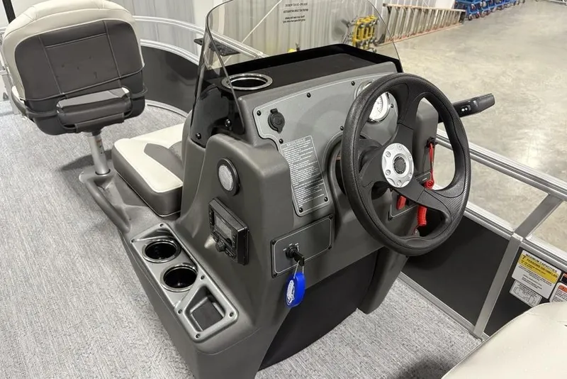 Slide: The Image of 2026 Sun Tracker Bass Buggy 16 XL Select boat console with steering wheel and seating. - 15