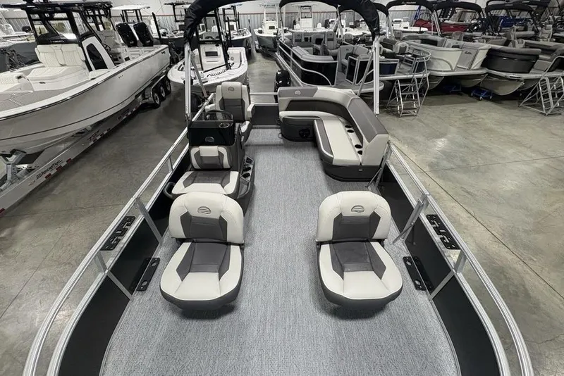 Slide: The Image of 2026 Sun Tracker Bass Buggy 16 XL Select pontoon boat interior, showroom display. - 16