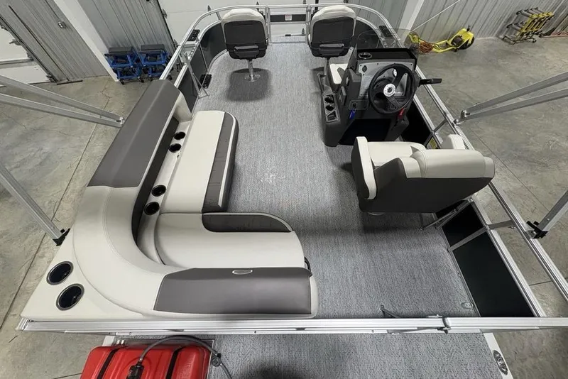 Slide: The Image of 2026 Sun Tracker Bass Buggy 16 XL Select pontoon boat interior with seating and steering console. - 18