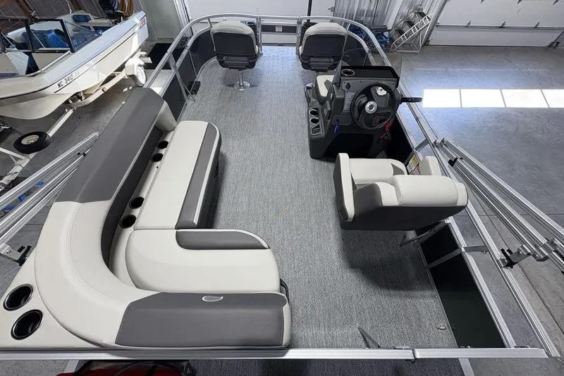 Slide: The Image of 2026 Sun Tracker Bass Buggy 16 XL Select pontoon boat interior with seating and steering console. - 19
