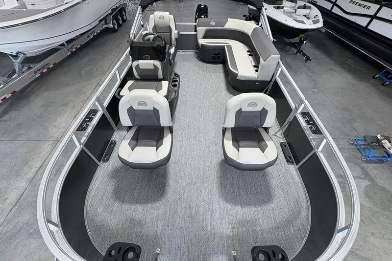 Slide: The Image of 2026 Sun Tracker Bass Buggy 16 XL Select pontoon boat interior with seating and steering console. - 21