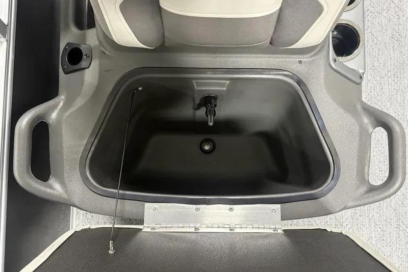 Slide: The Image of 2026 Sun Tracker Bass Buggy 16 XL Select boat storage compartment, featuring cup holders and handles. - 6