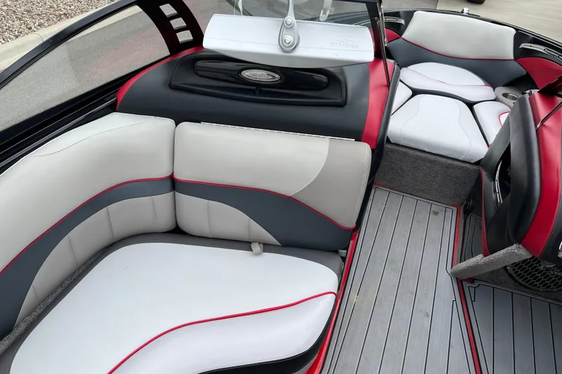 Slide: The Image of 2013 Malibu Wakesetter 23 LSV interior with stylish red, gray, and white seating. - 6