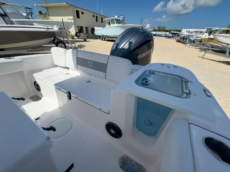 Slide: The Image of 2025 Sea Fox 228 Commander boat interior with Yamaha engine in a marina. - 11