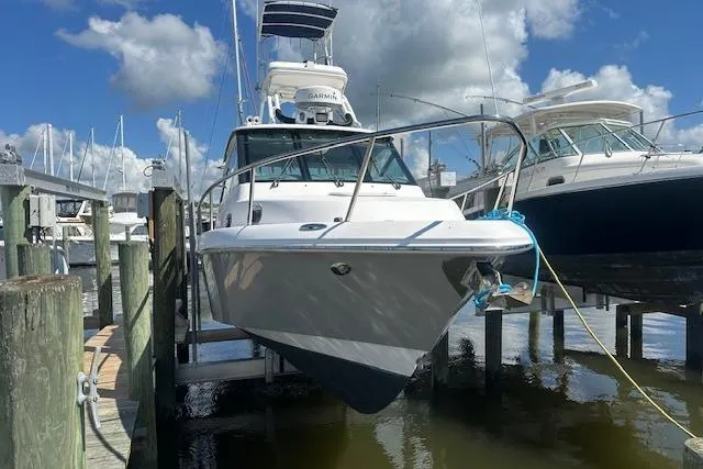 Slide: The Image of 2011 Everglades 320 EX with Tower docked at marina under blue sky. - 0