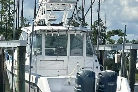 Slide: The Image of 2011 Everglades 320 EX with Tower docked, featuring dual Yamaha engines. - 3