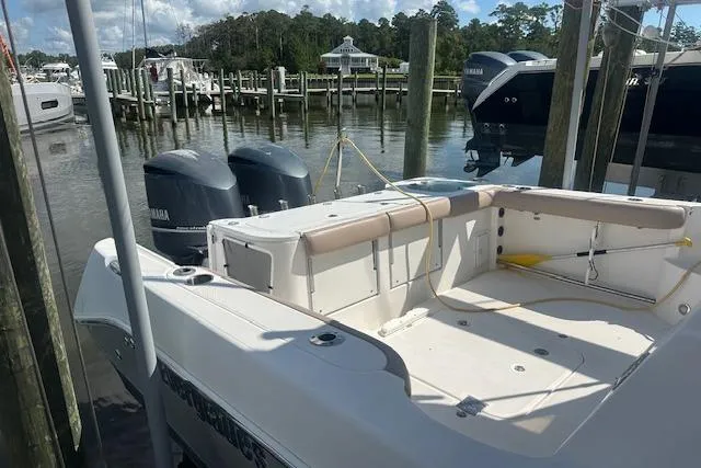 Slide: The Image of 2011 Everglades 320 EX with Tower docked, featuring dual Yamaha engines, in a marina setting. - 5