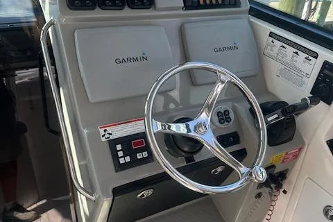 Slide: The Image of 2011 Everglades 320 EX boat helm with Garmin navigation system and steering wheel. - 6