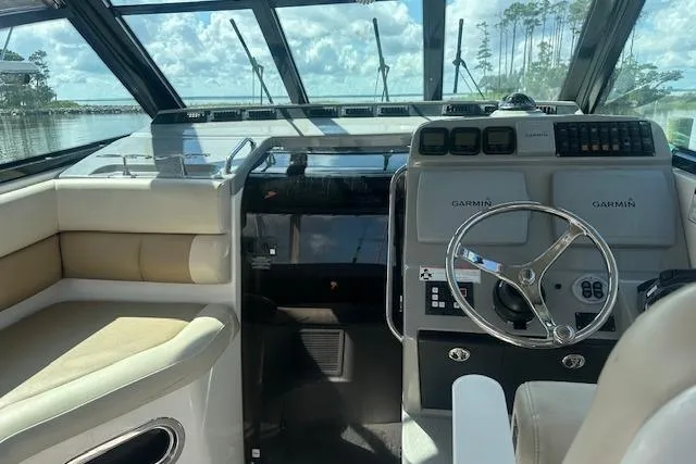 Slide: The Image of Interior view of 2011 Everglades 320 EX boat with steering wheel and Garmin navigation. - 7