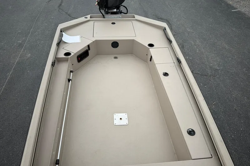 Slide: The Image of 2026 Avid 16 Commander boat interior, featuring spacious deck and storage compartments. - 11