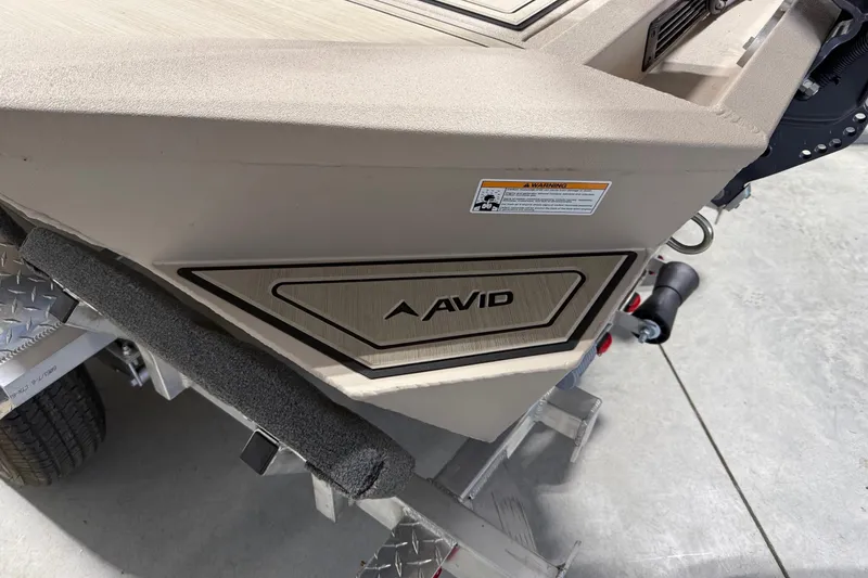 Slide: The Image of 2026 Avid 16 Commander boat on trailer, showcasing brand logo and design details. - 14