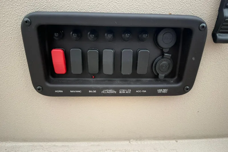 Slide: The Image of Control panel of 2026 Avid 16 Commander boat with labeled switches and USB ports. - 6