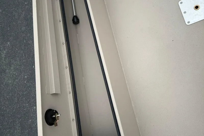 Slide: The Image of Interior view of 2026 Avid 16 Commander boat, featuring storage compartment and key lock. - 8